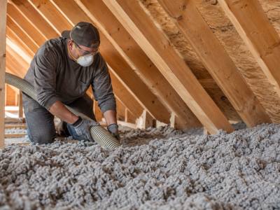 Close-up of cellulose insulation settling between attic joists