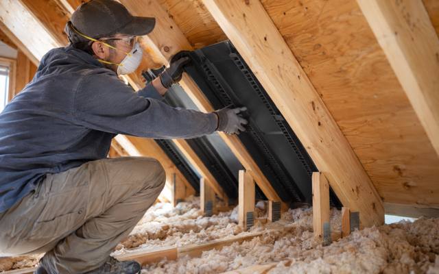 Attic ventilation baffles being installed at the eaves before insulation in Innisfil, Ontario