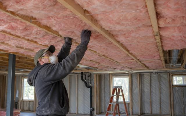Batt insulation going into the floor joists above an unfinished Innisfil basement