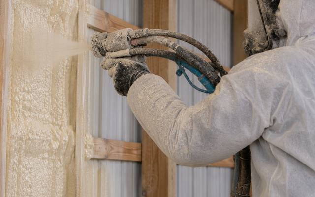 Spray foam insulation applied to the inside of a steel building wall in Simcoe County