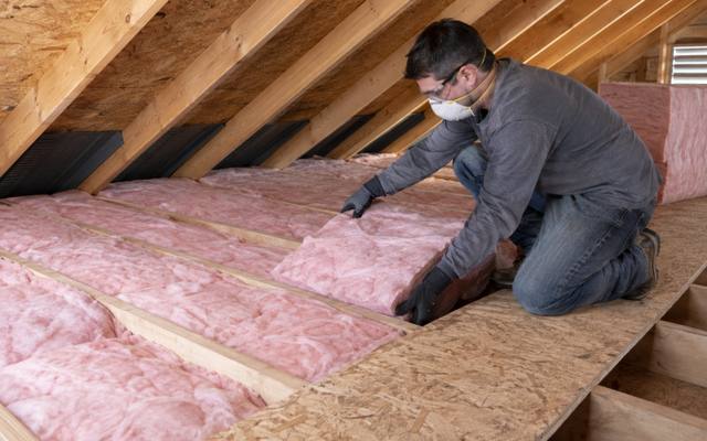 Batt insulation laid between the rafters of a steep cottage attic near Lake Simcoe