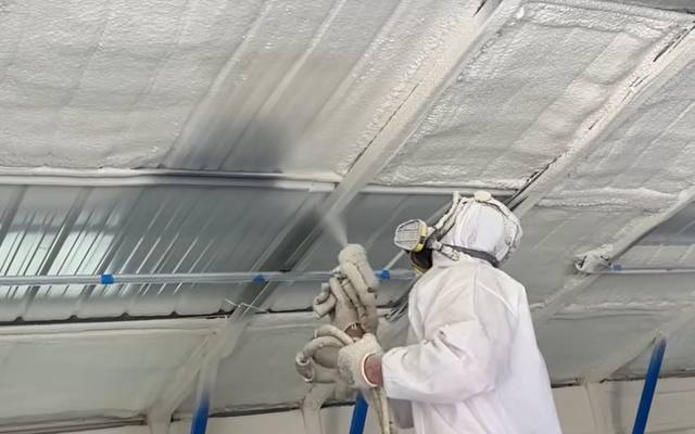 Spray foam insulation across the underside of a garage roof deck in Innisfil